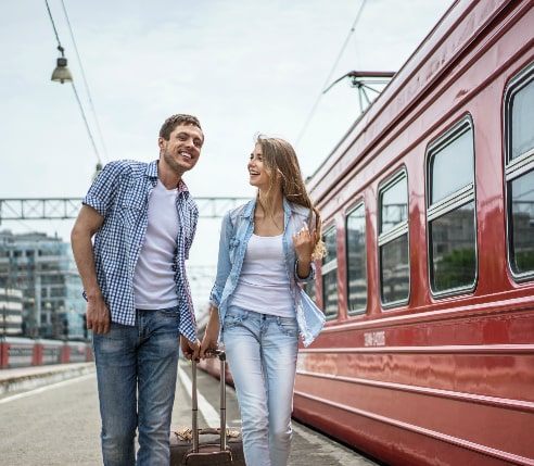 A couple on the railway station waiting for a train